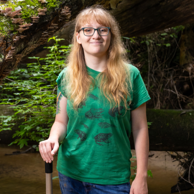 Cassie Ellenberger standing outdoors in a stream.